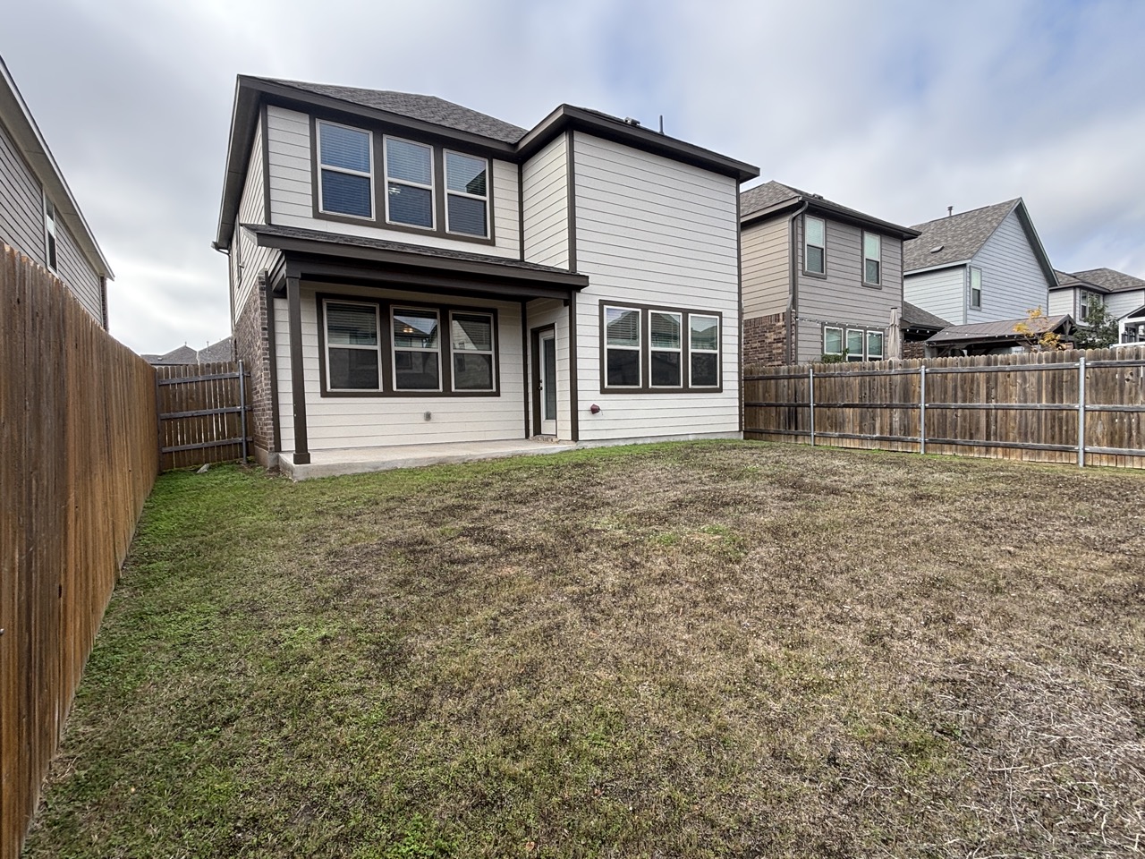 7606 Elk Grove Path Austin, TX 78754 - Photo 32 of 40 Back of property with a patio area and a fenced backyard