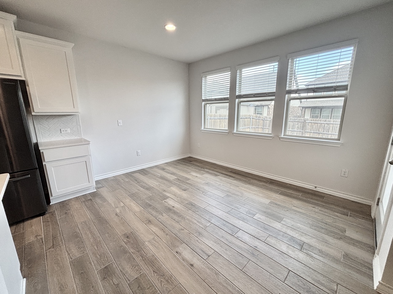 7606 Elk Grove Path Austin, TX 78754 - Photo 7 of 40 Unfurnished dining area with light wood-style flooring and recessed lighting