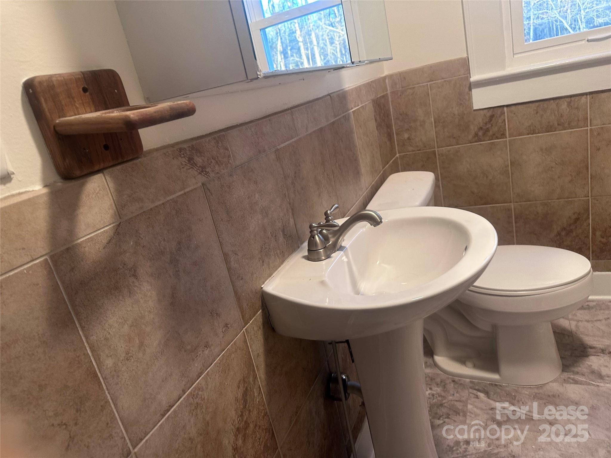 1255 Highway 24 Midland, NC 28107 - Photo 20 of 27 a bathroom with a sink toilet and a mirror