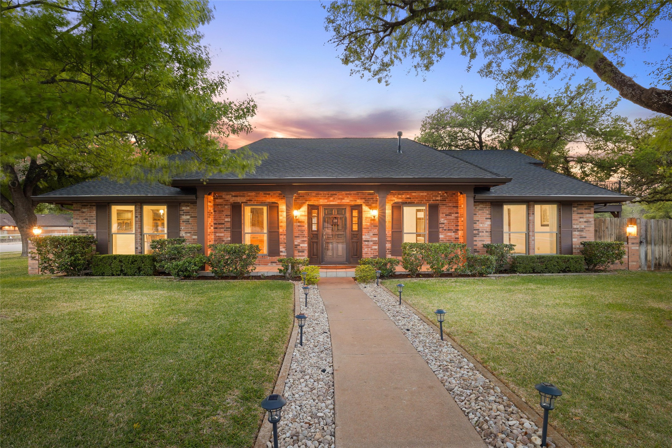 7202 Rolling Meadow Road Austin, TX 78749 - Photo 1 of 1 View of front of property with a porch, a front lawn, and brick siding