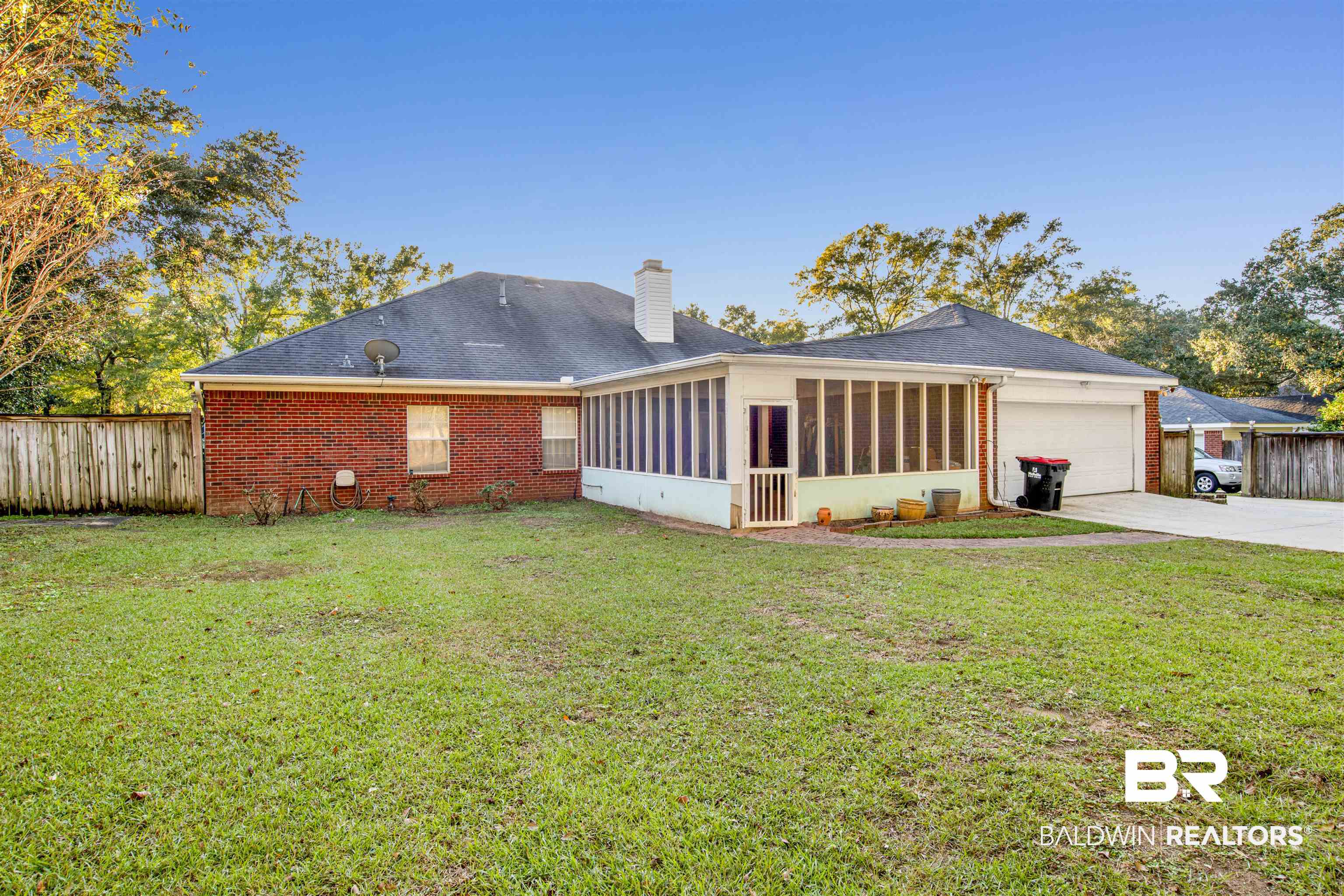 445 Wedgefield Drive South Mobile, AL 36608 - Photo 35 of 36 Rear view of house with a sunroom, a yard, and a garage