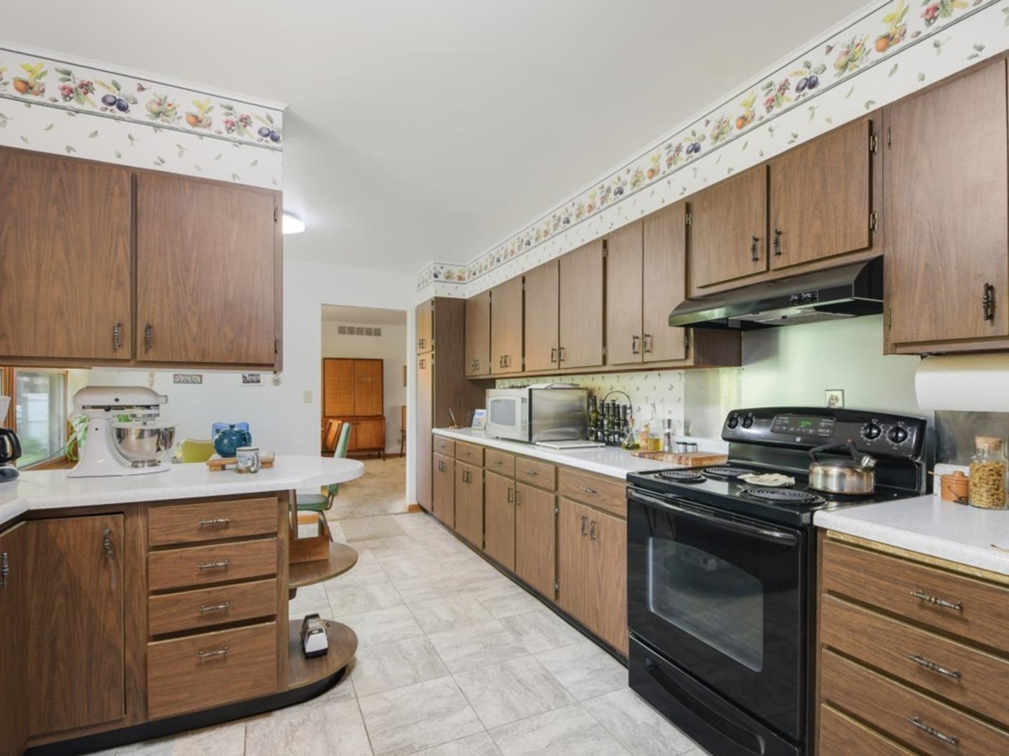 802 Adams Court Monticello, IL 61856 - Photo 9 of 25 a kitchen with granite countertop a sink a stove and cabinets