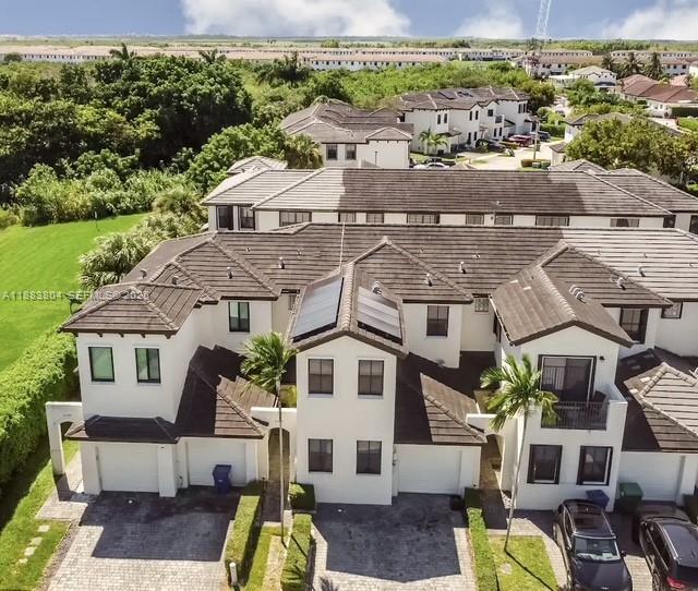 an aerial view of residential houses with outdoor space and street view