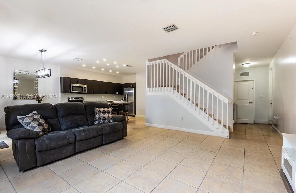 22509 Southwest 102nd Avenue Miami, FL 33190 - Photo 18 of 39 a living room with furniture and a flat screen tv