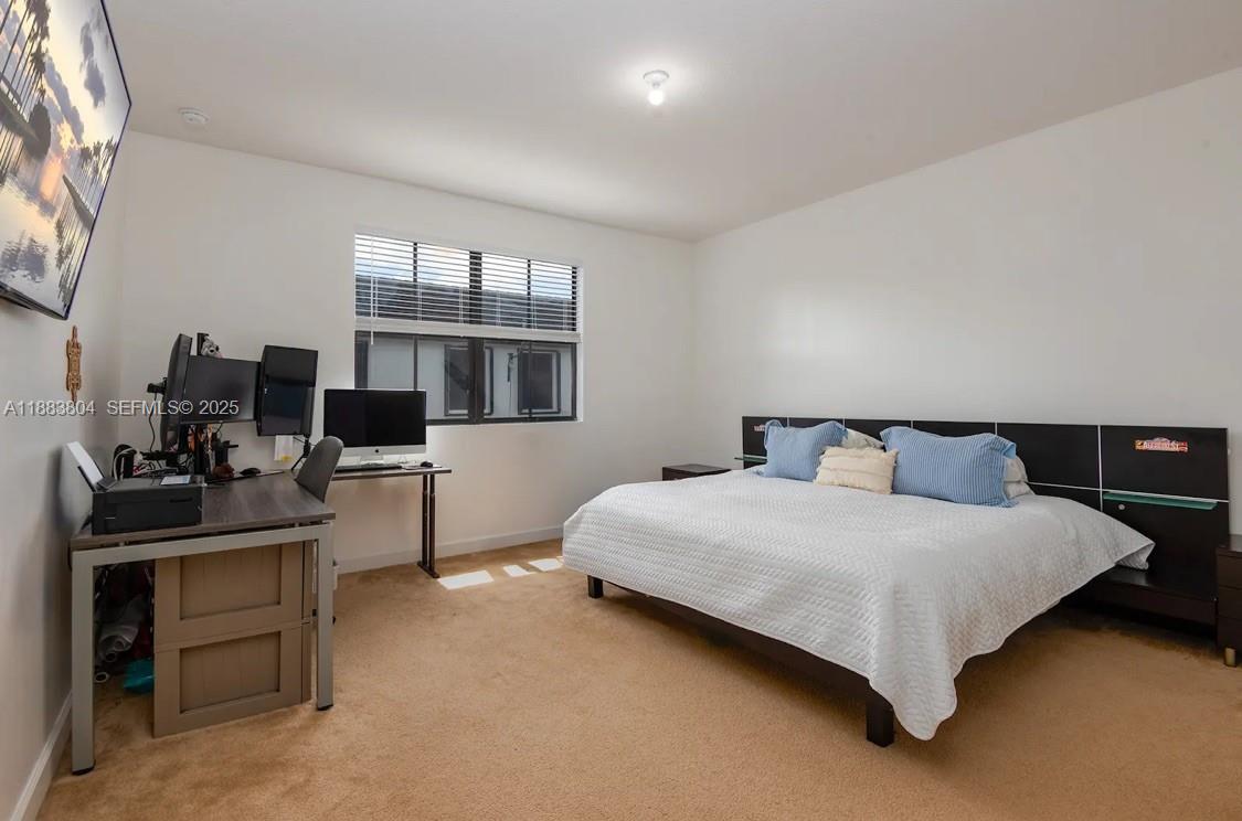 22509 Southwest 102nd Avenue Miami, FL 33190 - Photo 22 of 39 a bedroom with a bed and a desk