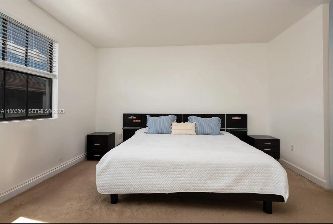 22509 Southwest 102nd Avenue Miami, FL 33190 - Photo 23 of 39 a bedroom with a bed and a flat tv screen on a dresser