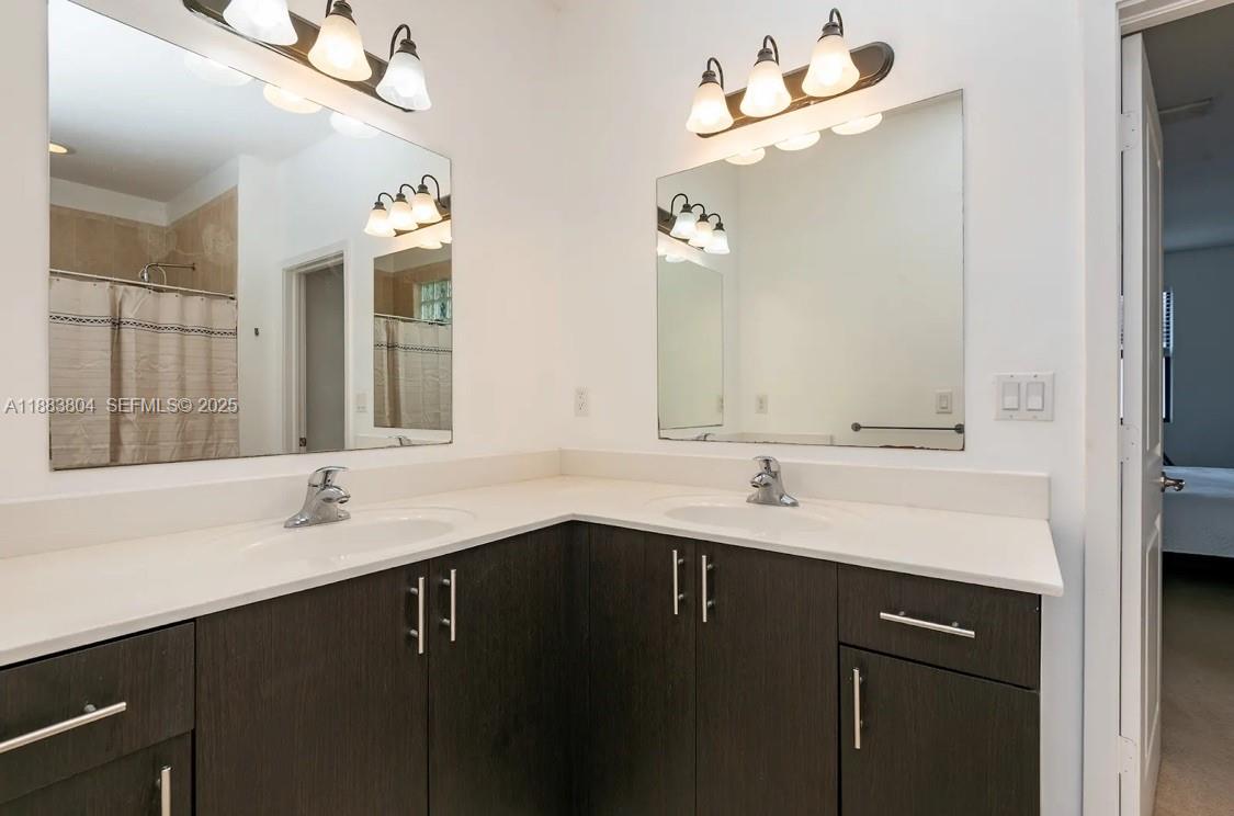 22509 Southwest 102nd Avenue Miami, FL 33190 - Photo 27 of 39 a bathroom with a sink and a mirror