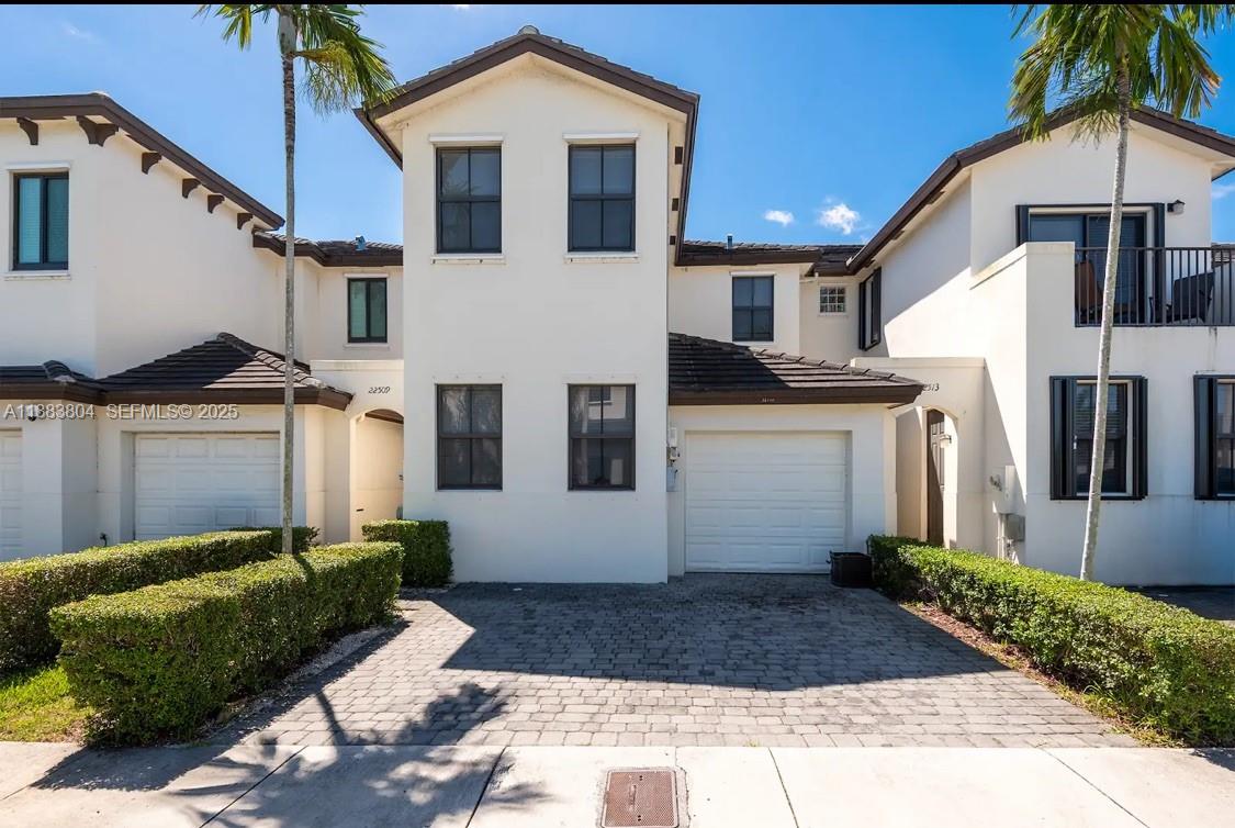 22509 Southwest 102nd Avenue Miami, FL 33190 - Photo 3 of 39 a view of a white house with a small yard and plants