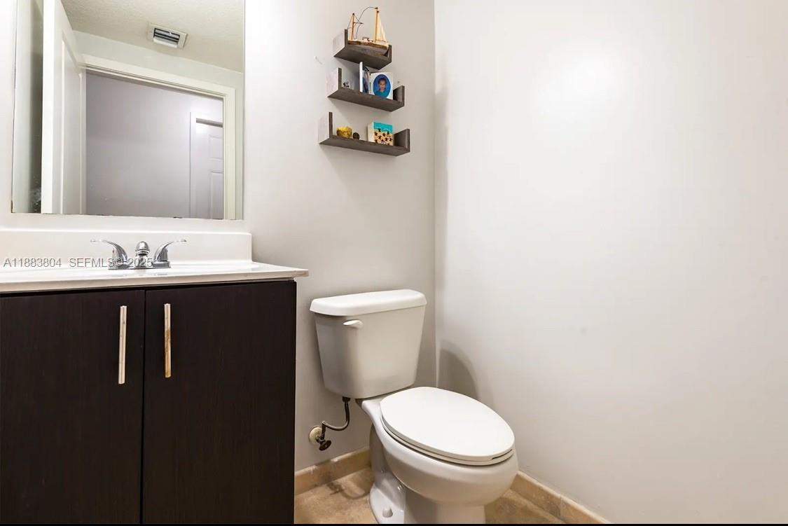 22509 Southwest 102nd Avenue Miami, FL 33190 - Photo 34 of 39 a bathroom with a toilet sink and mirror