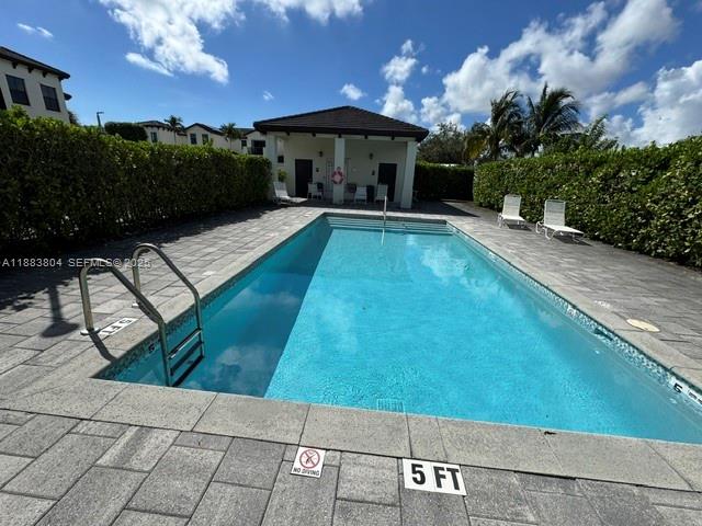 22509 Southwest 102nd Avenue Miami, FL 33190 - Photo 9 of 39 a view of a swimming pool with a patio