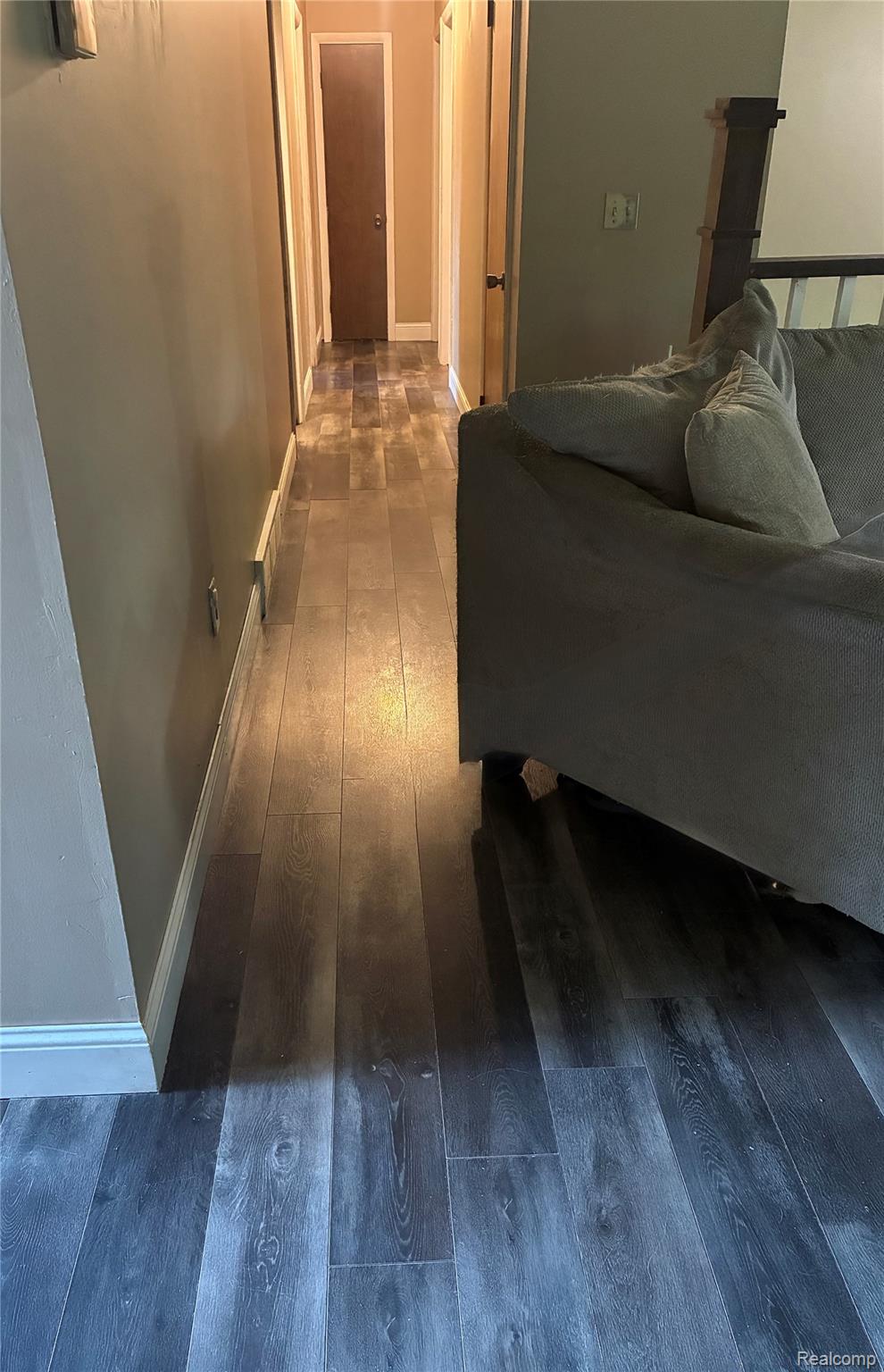 10340 Farrand Road Montrose, MI 48457 - Photo 13 of 31 Wood-finish flooring throughout, featuring a hallway with solid core doors and white trim