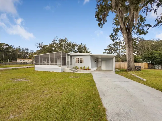 a front view of a house with swimming pool having outdoor seating