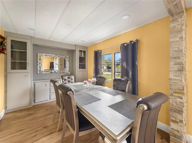 a view of a dining room with furniture window and wooden floor