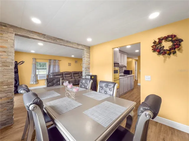 a view of a dining room with furniture and a potted plant
