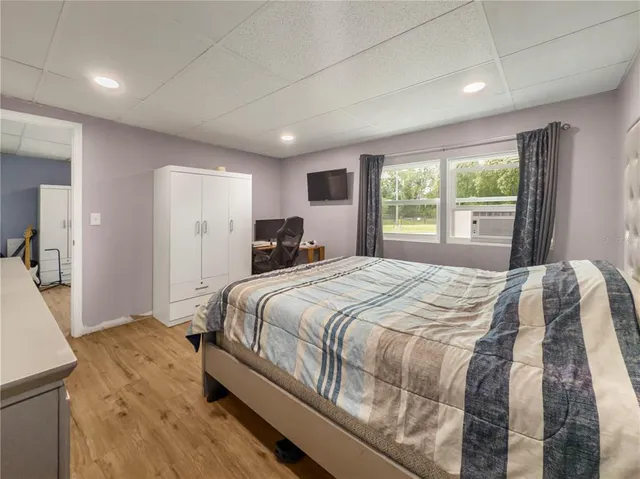 a bedroom with a large bed and a large window