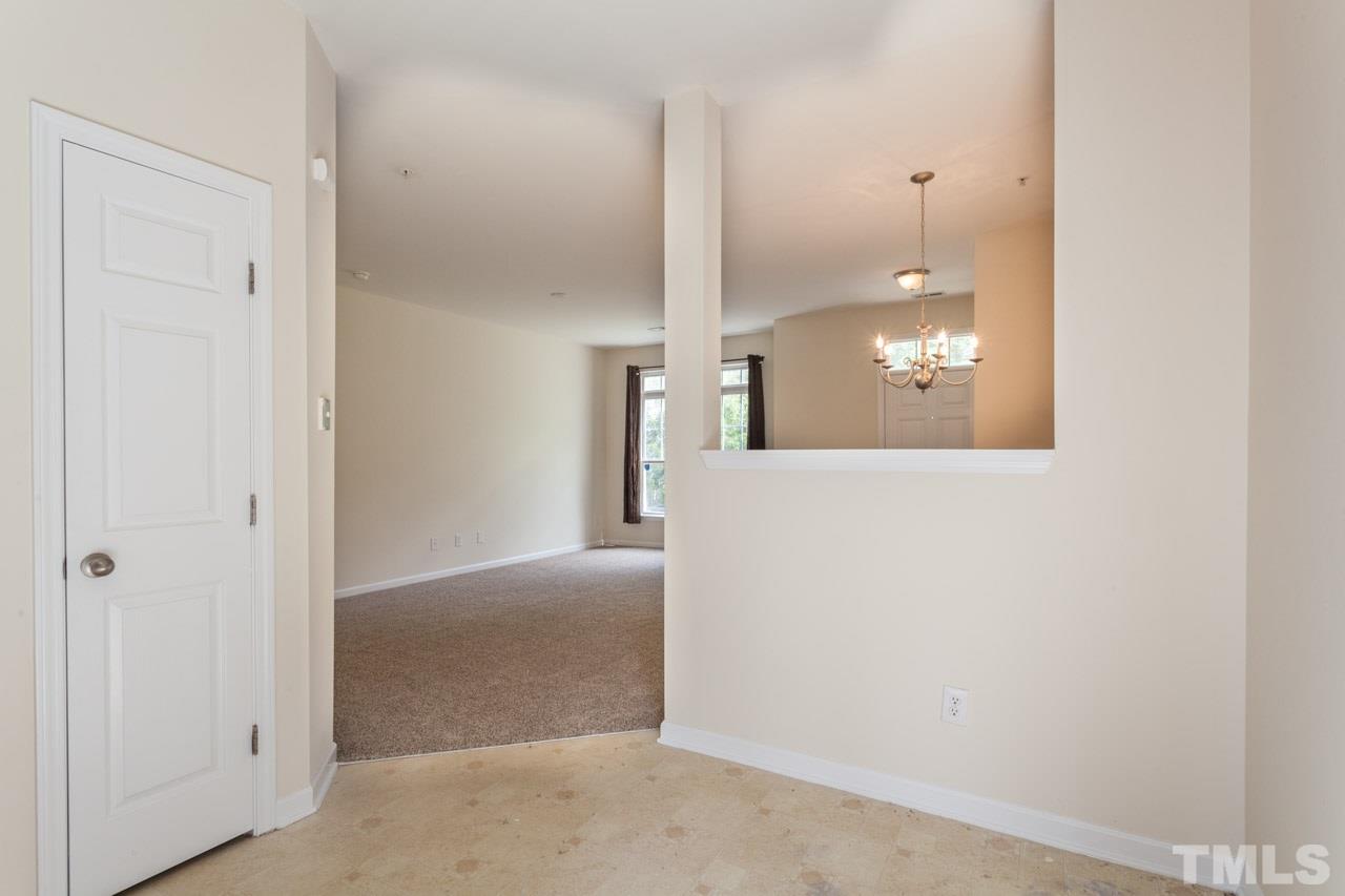 8631 Neuse Club Lane, Unit 100 Raleigh, NC 27616 - Photo 13 of 25 a view of a hallway with wooden floor