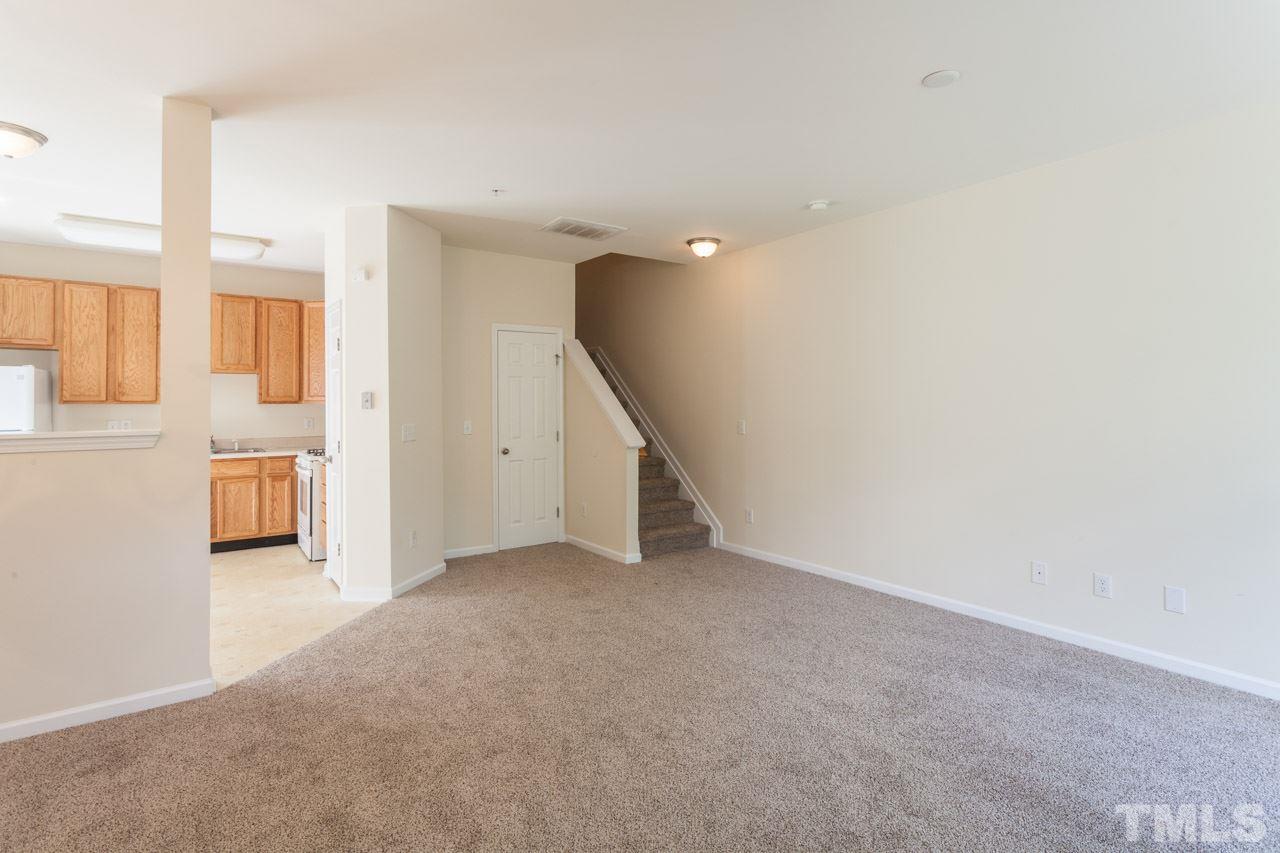 8631 Neuse Club Lane, Unit 100 Raleigh, NC 27616 - Photo 15 of 25 a view of an empty room with stairs