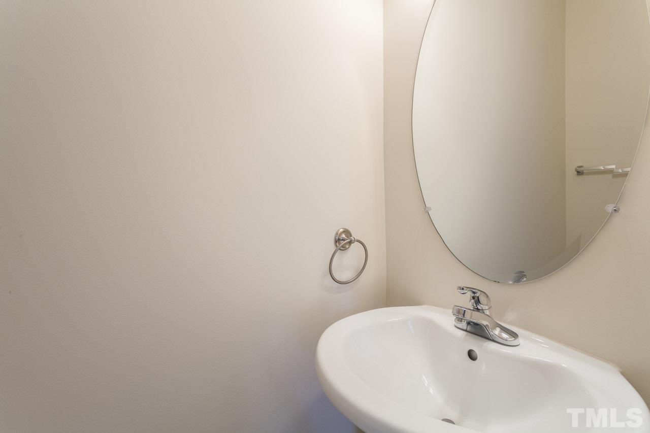 8631 Neuse Club Lane, Unit 100 Raleigh, NC 27616 - Photo 16 of 25 a bathroom with a sink and mirror