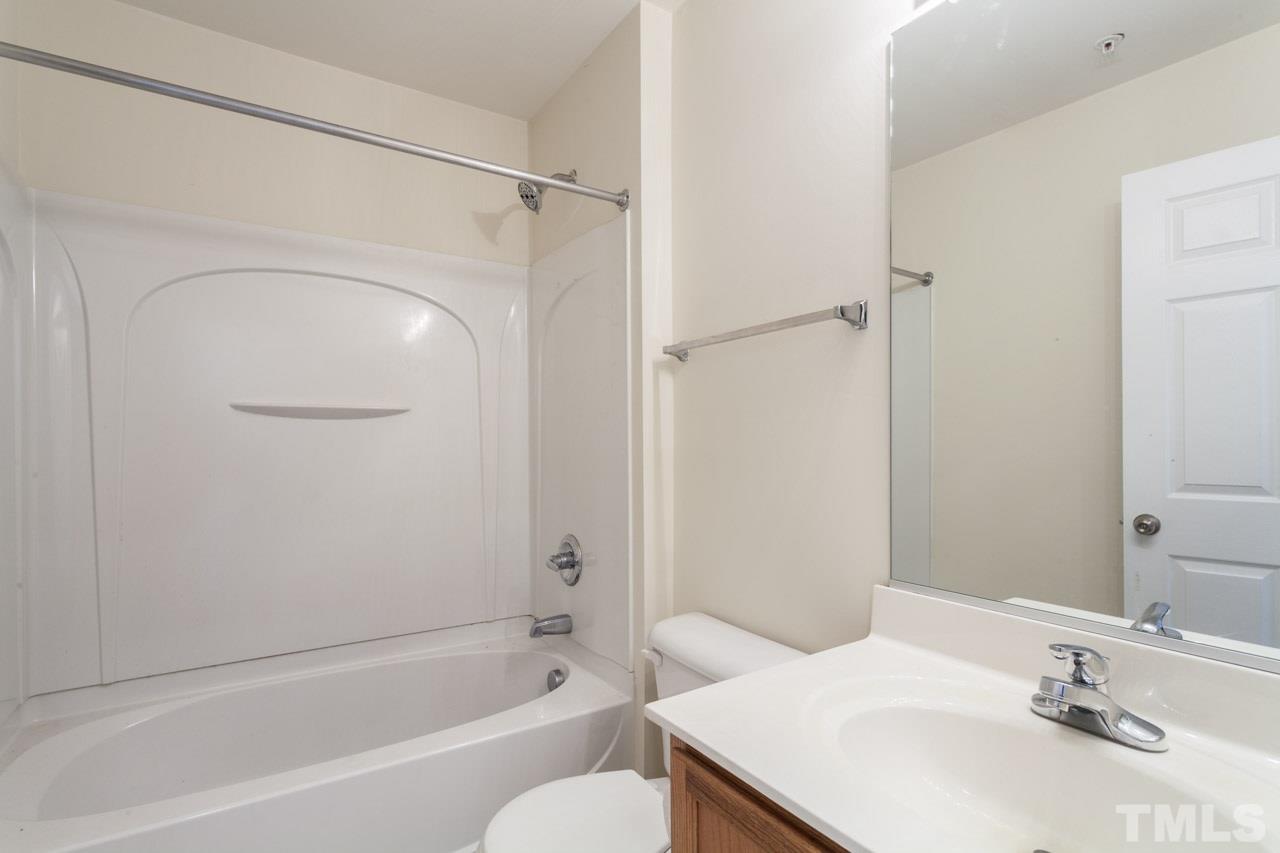 8631 Neuse Club Lane, Unit 100 Raleigh, NC 27616 - Photo 20 of 25 a bathroom with a sink toilet and shower