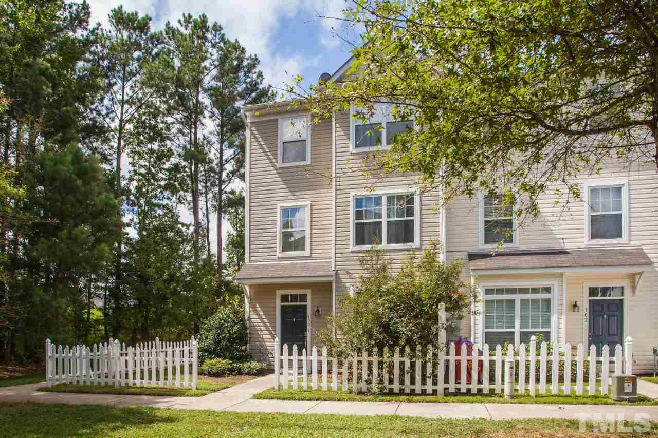 8631 Neuse Club Lane, Unit 100 Raleigh, NC 27616 - Photo 3 of 25 a front view of a house with a garden