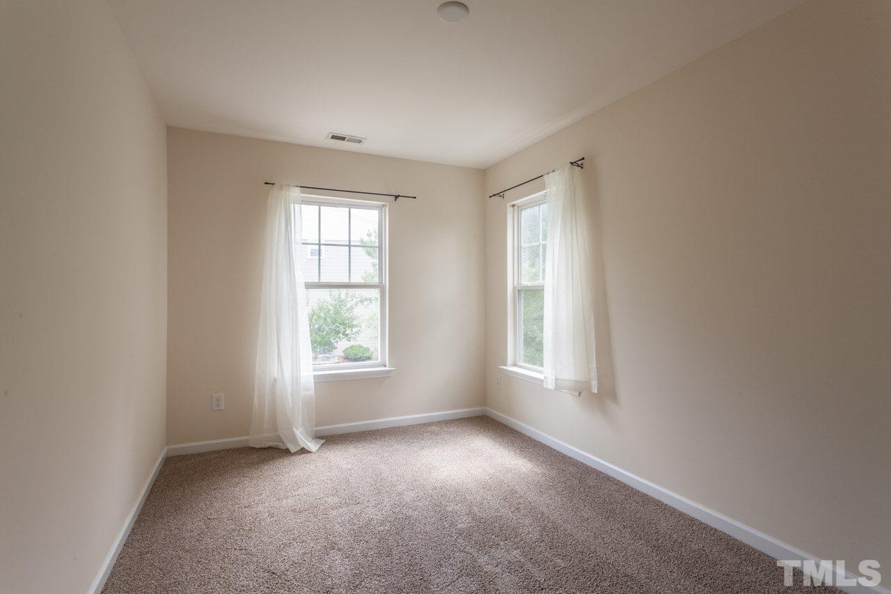 8631 Neuse Club Lane, Unit 100 Raleigh, NC 27616 - Photo 21 of 25 an empty room with windows