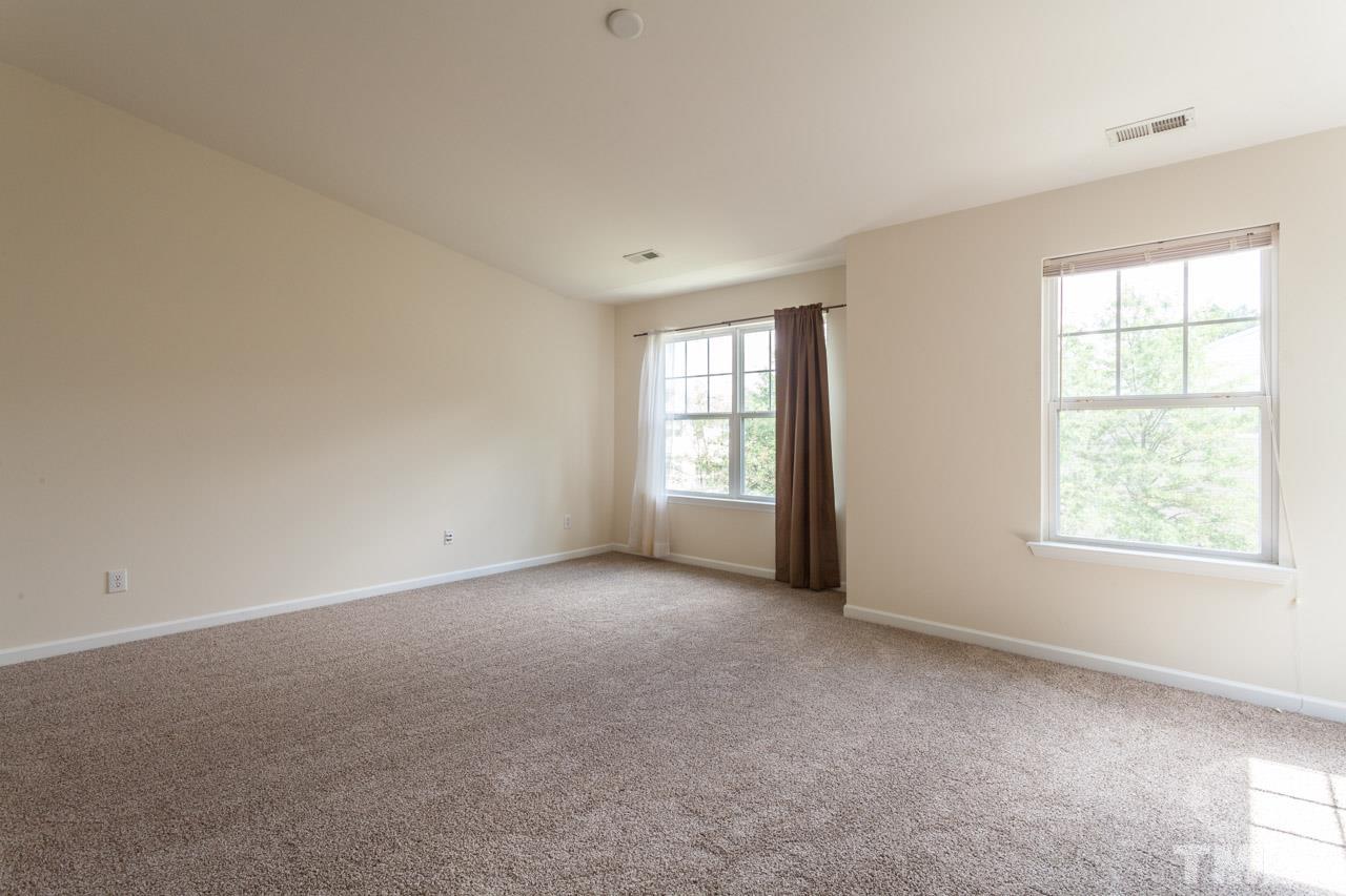 8631 Neuse Club Lane, Unit 100 Raleigh, NC 27616 - Photo 22 of 25 an empty room with windows