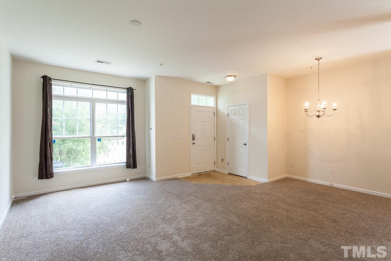 8631 Neuse Club Lane, Unit 100 Raleigh, NC 27616 - Photo 5 of 25 a view of an empty room with a window