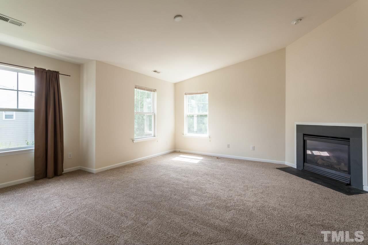 8631 Neuse Club Lane, Unit 100 Raleigh, NC 27616 - Photo 6 of 25 a view of empty room with a fireplace