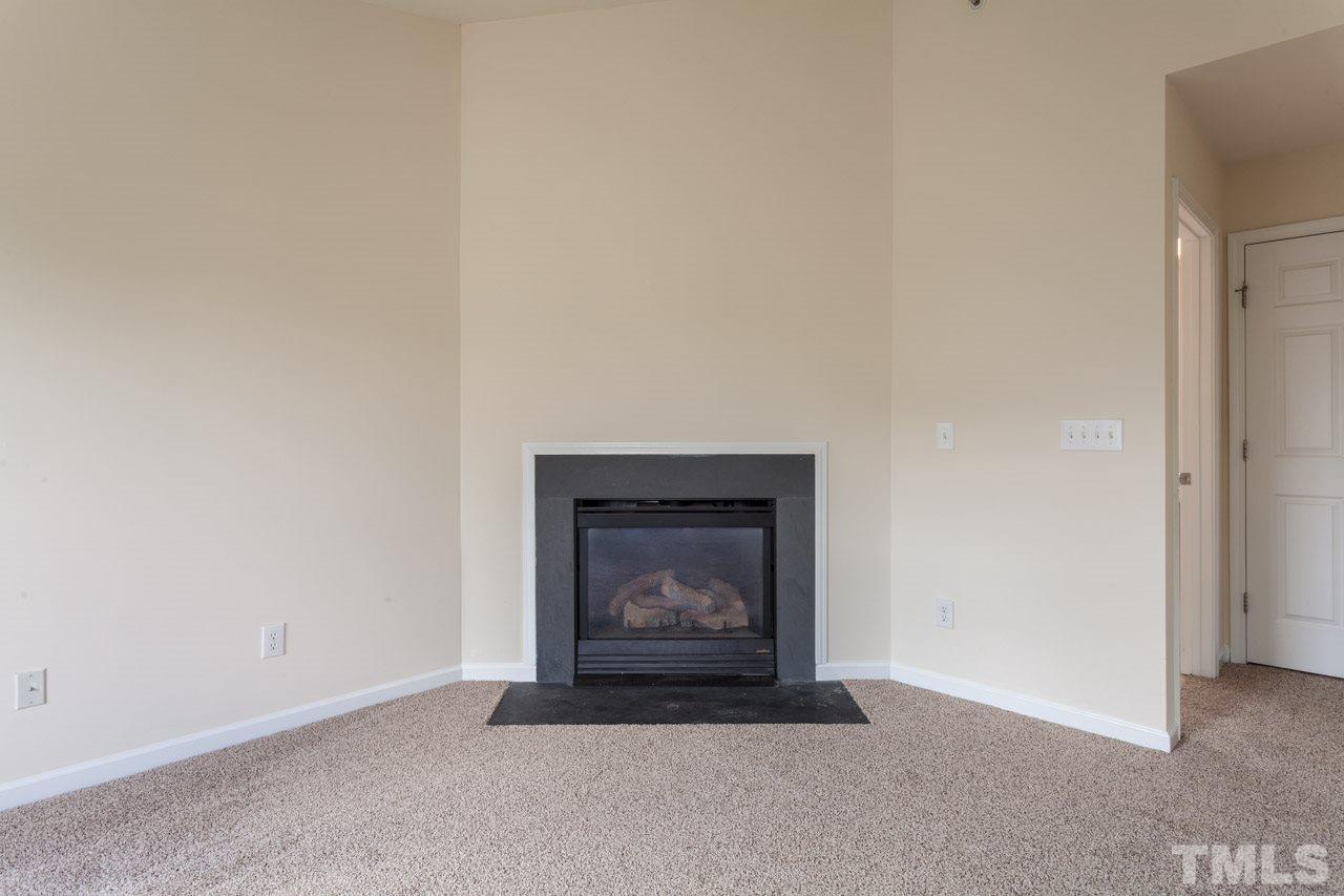 8631 Neuse Club Lane, Unit 100 Raleigh, NC 27616 - Photo 7 of 25 a room with a fireplace