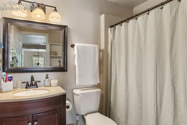 a bathroom with a sink vanity mirror and toilet