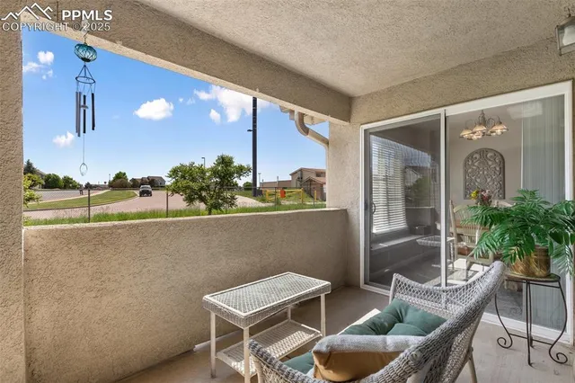 a balcony with table and chairs