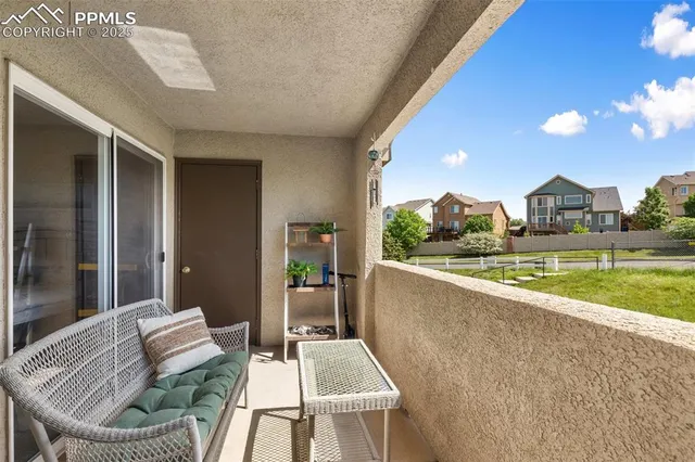 a view of a patio with couches table and chairs and potted plants