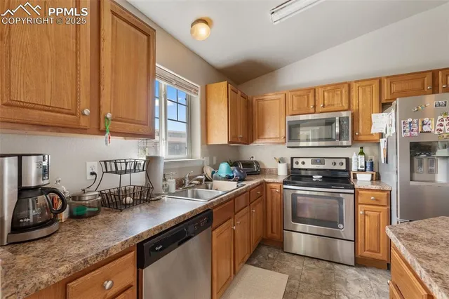 a kitchen with stainless steel appliances granite countertop a sink stove and microwave