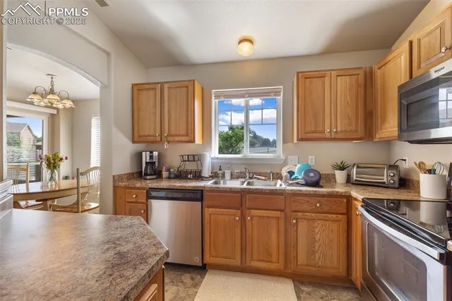 a kitchen with a sink stove top oven and microwave