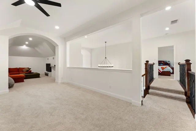 a living room with furniture and a ceiling fan