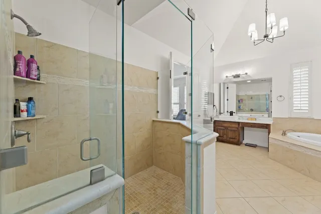 a large bathroom with a large mirror vanity and shower