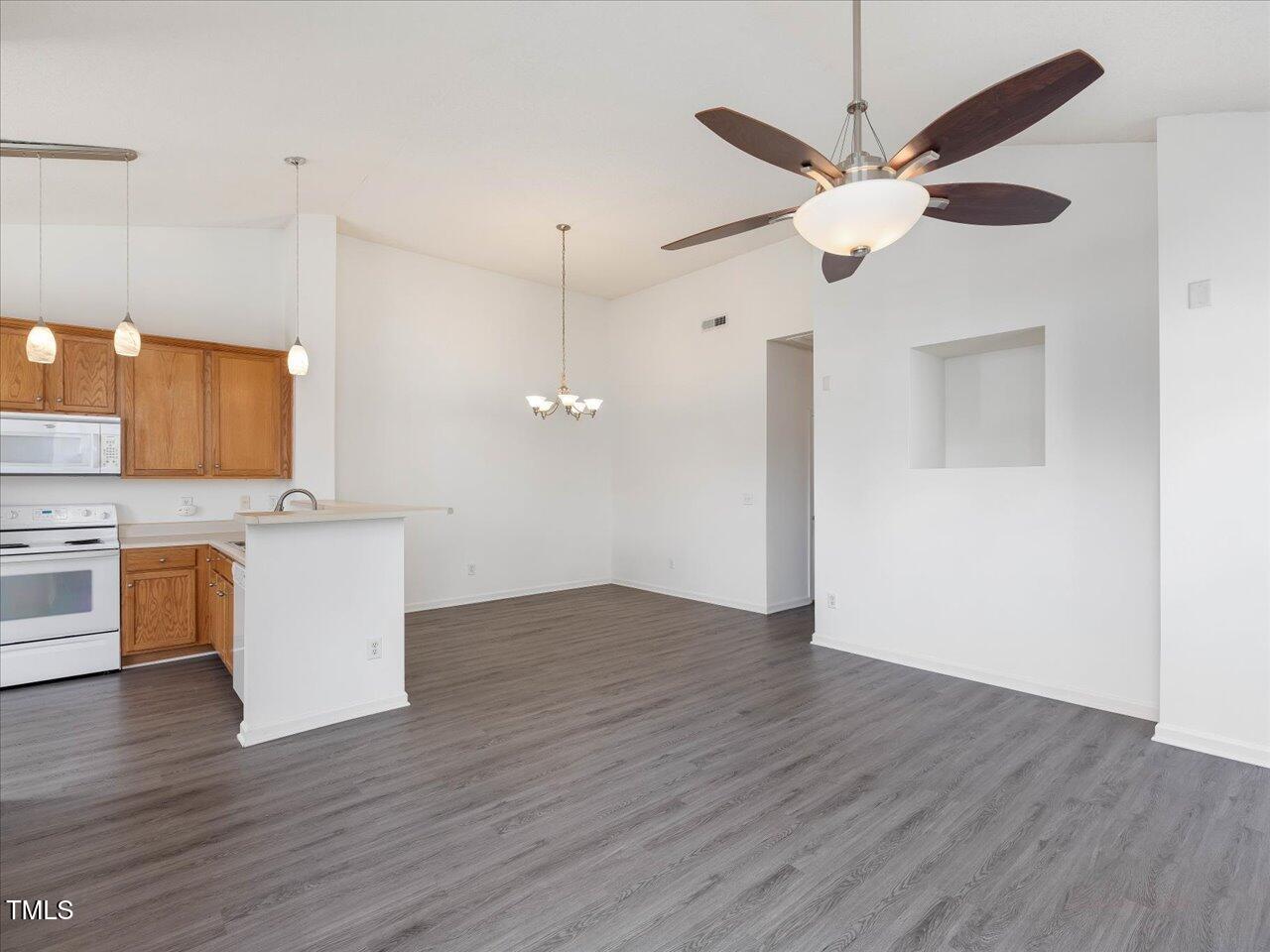 522 Auburn Square Drive Durham, NC 27713 - Photo 10 of 47 a view of a kitchen with a microwave and wooden floor
