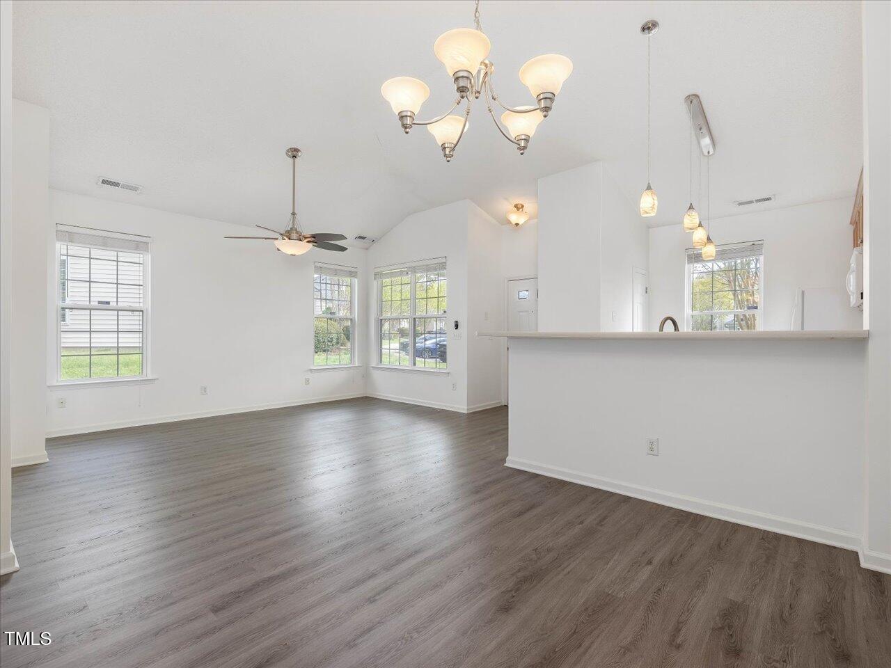 522 Auburn Square Drive Durham, NC 27713 - Photo 12 of 47 an empty room with wooden floor fan and windows