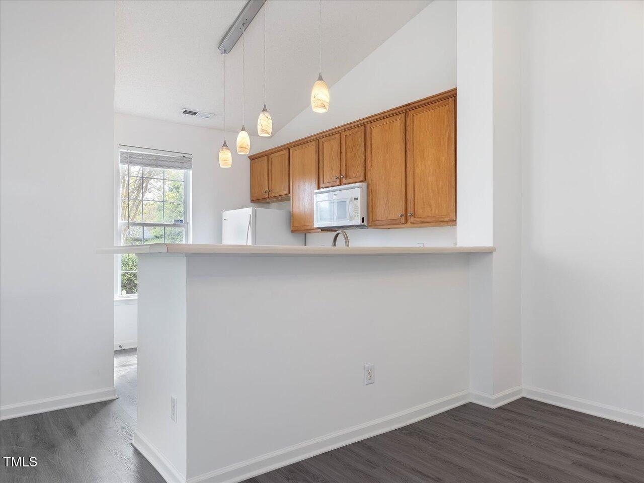 522 Auburn Square Drive Durham, NC 27713 - Photo 13 of 47 a view of kitchen with wooden floor and electronic appliances
