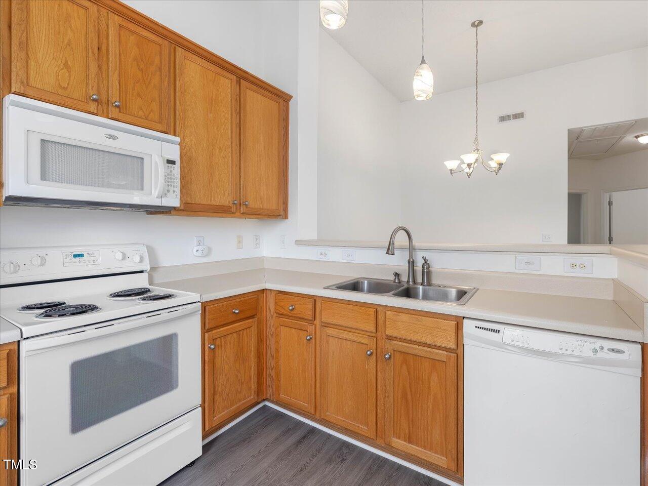 522 Auburn Square Drive Durham, NC 27713 - Photo 15 of 47 a kitchen with sink a microwave and cabinets