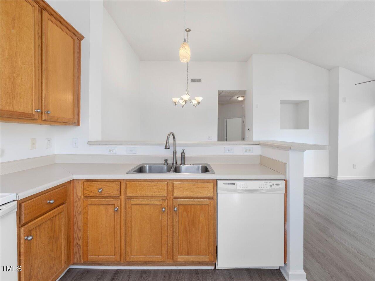 522 Auburn Square Drive Durham, NC 27713 - Photo 16 of 47 a kitchen with a sink cabinets and wooden floor