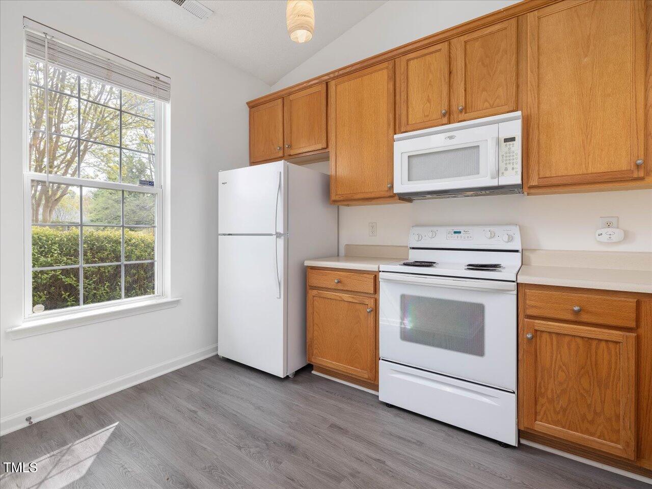 522 Auburn Square Drive Durham, NC 27713 - Photo 18 of 47 a kitchen with a stove microwave and a sink