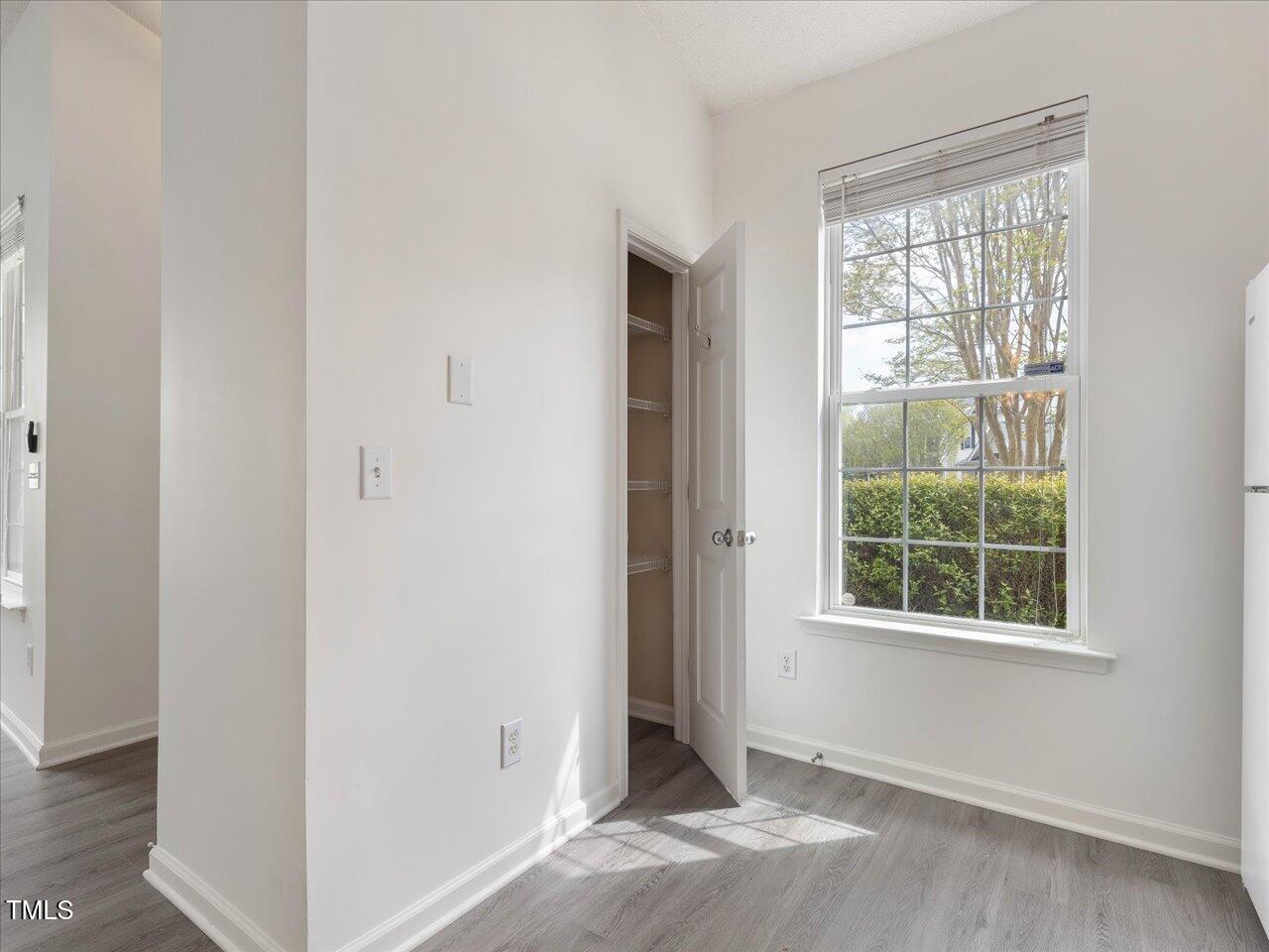 522 Auburn Square Drive Durham, NC 27713 - Photo 19 of 47 a view of an empty room with window and wooden floor