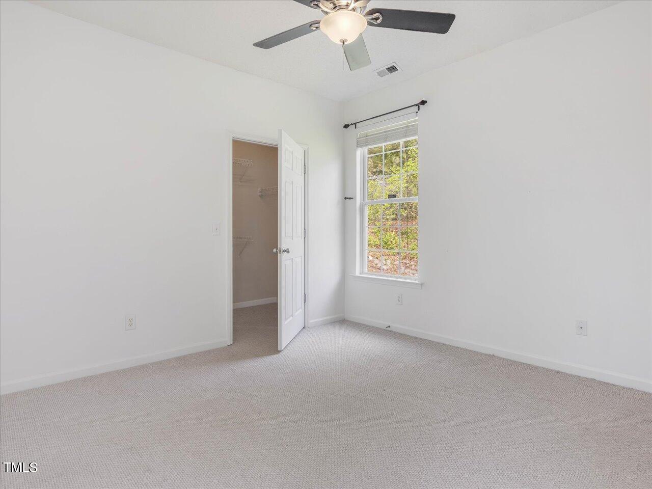 522 Auburn Square Drive Durham, NC 27713 - Photo 21 of 47 an empty room with a window and a ceiling fan