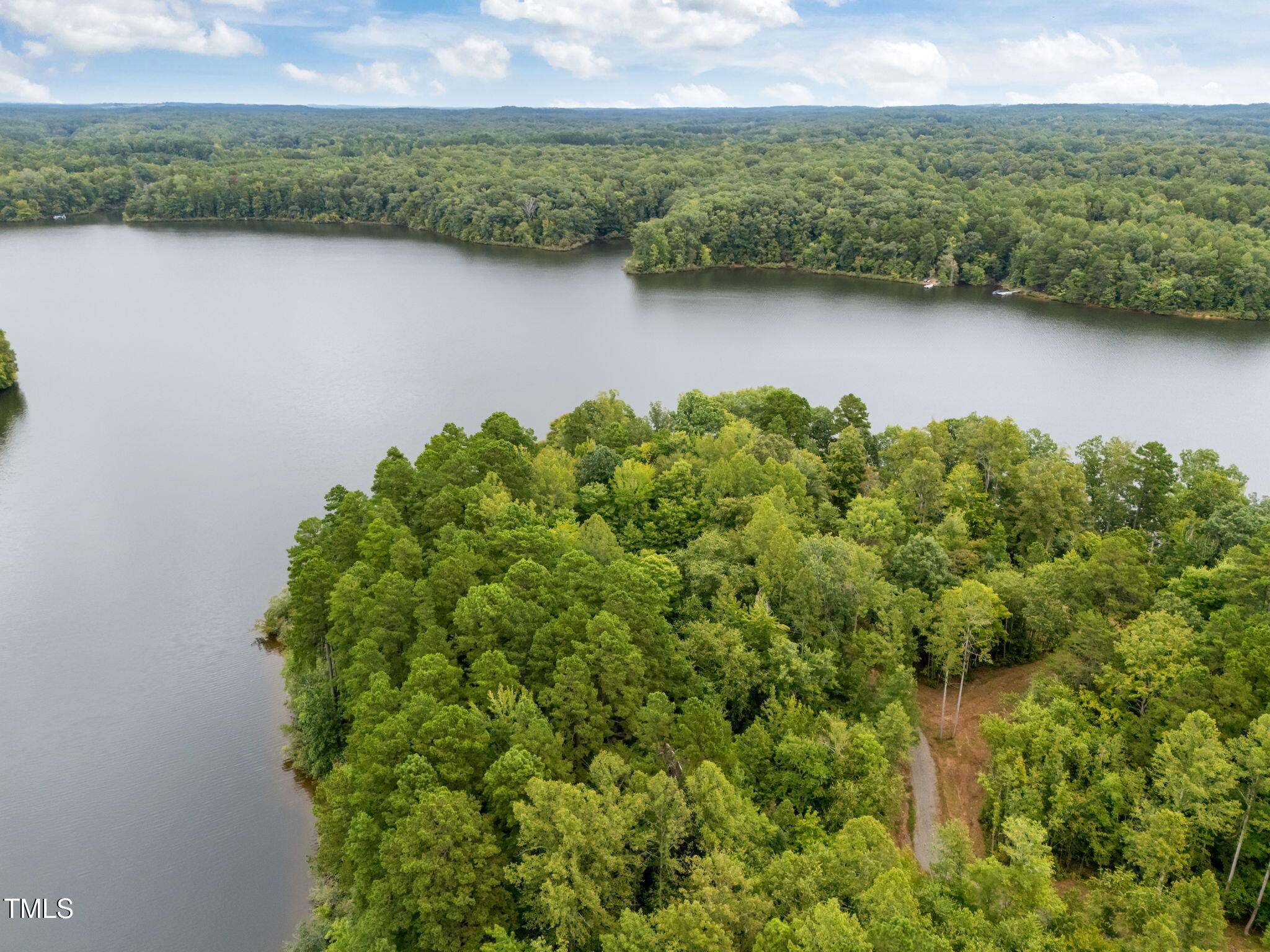 Lot 3 Grapevine Drive Roxboro, NC 27574 - Photo 2 of 17 a view of a lake with green landscape and trees