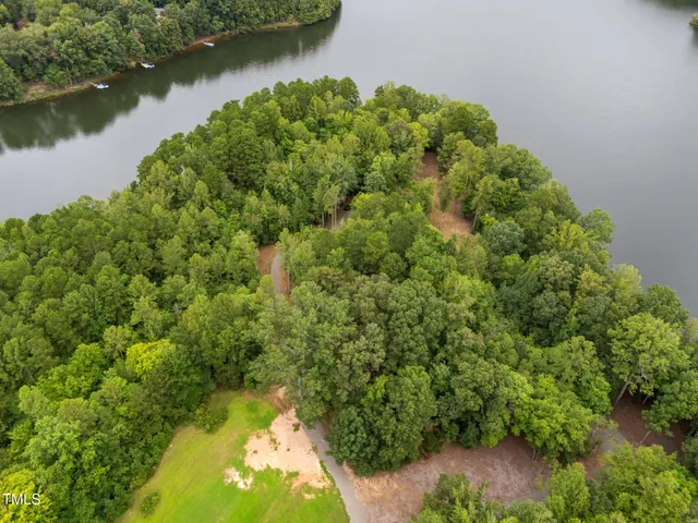 a backyard of a house with lots of green space and garden