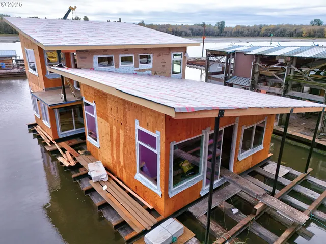a view of a patio with table and chairs with wooden floor and fence