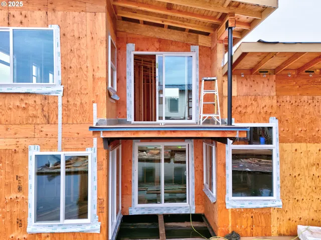 a view of a brick house with large windows