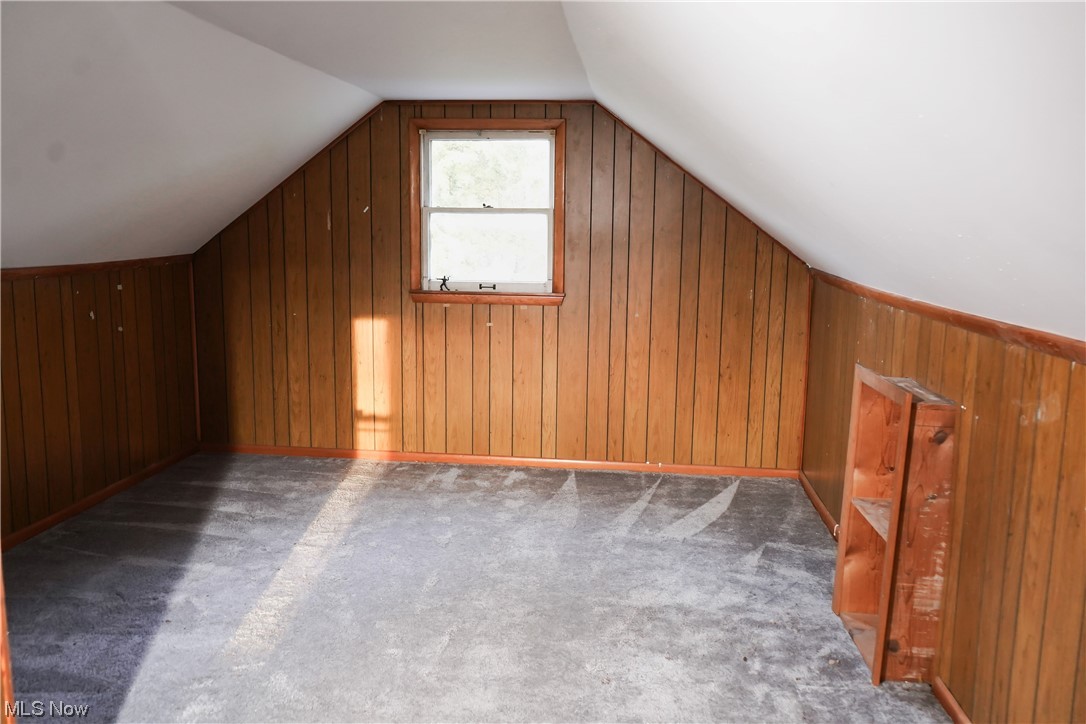 326 Pangborn Road Leavittsburg, OH 44430 - Photo 9 of 25 Bonus room with wooden walls, dark carpet, and vaulted ceiling