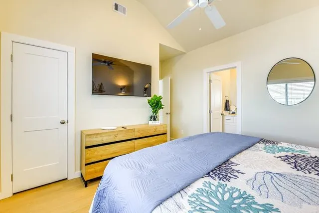 a bedroom with a bed and a flat screen tv